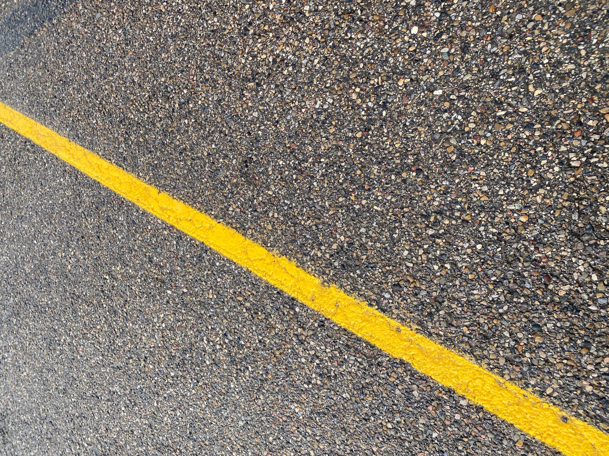 A yellow line on a roadway.